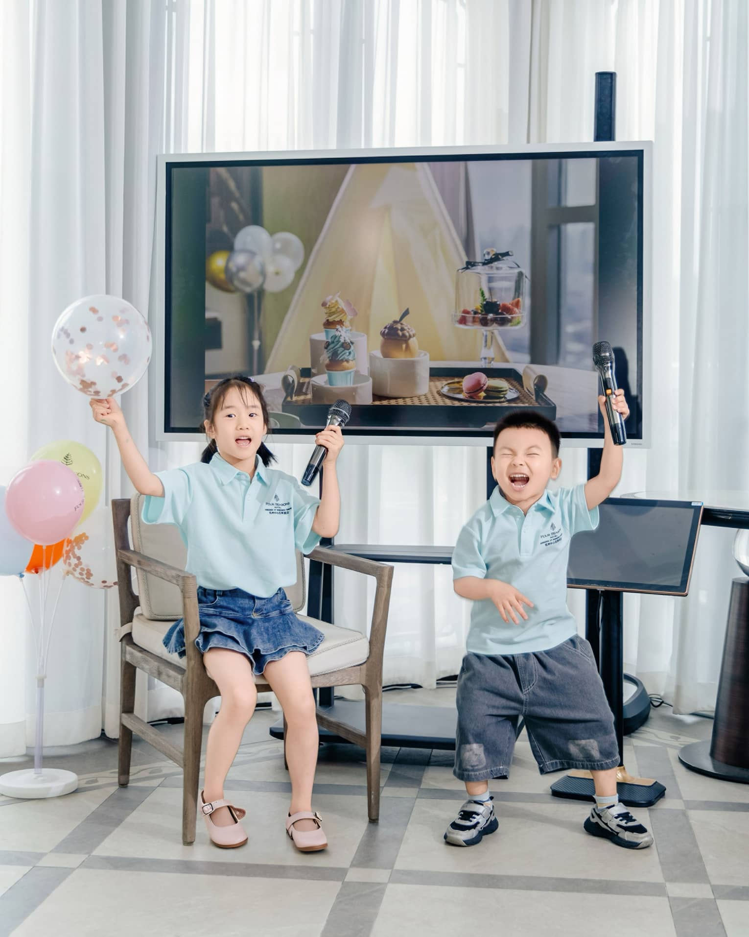Two young children get ready for karaoke