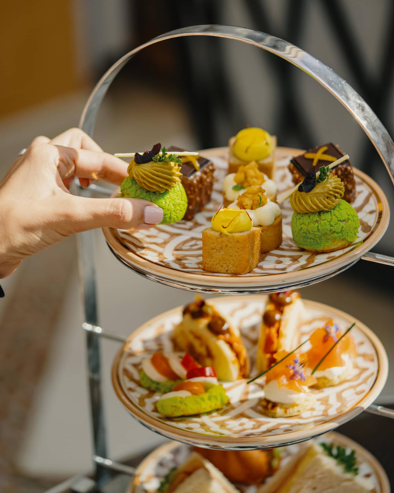 A spread of pastries on a three-tiered stand