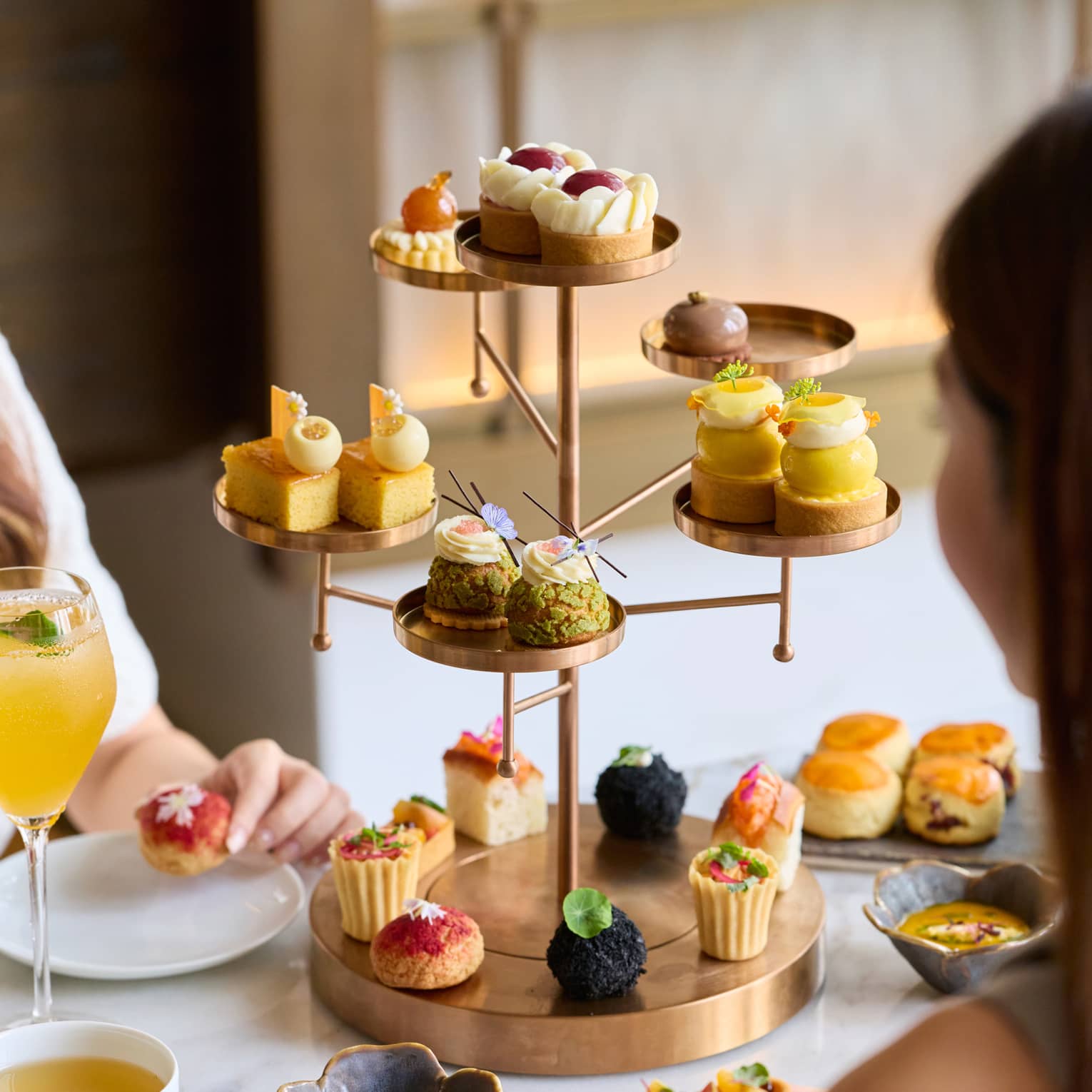 Tree-shapped serving tray filled with bite-sized pastries for afternoon tea