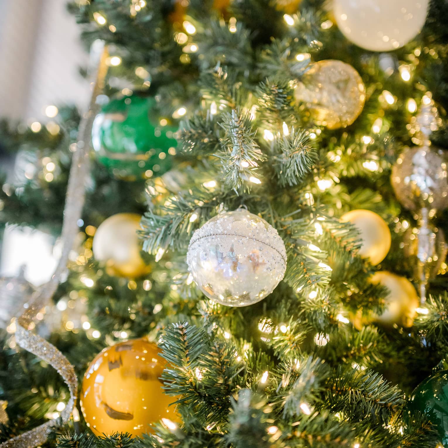 Tree decorated with sparkling ornaments and lights.