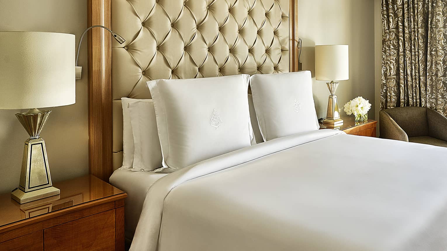 Four Seasons Suite, showing white-dressed bed and city views from windows
