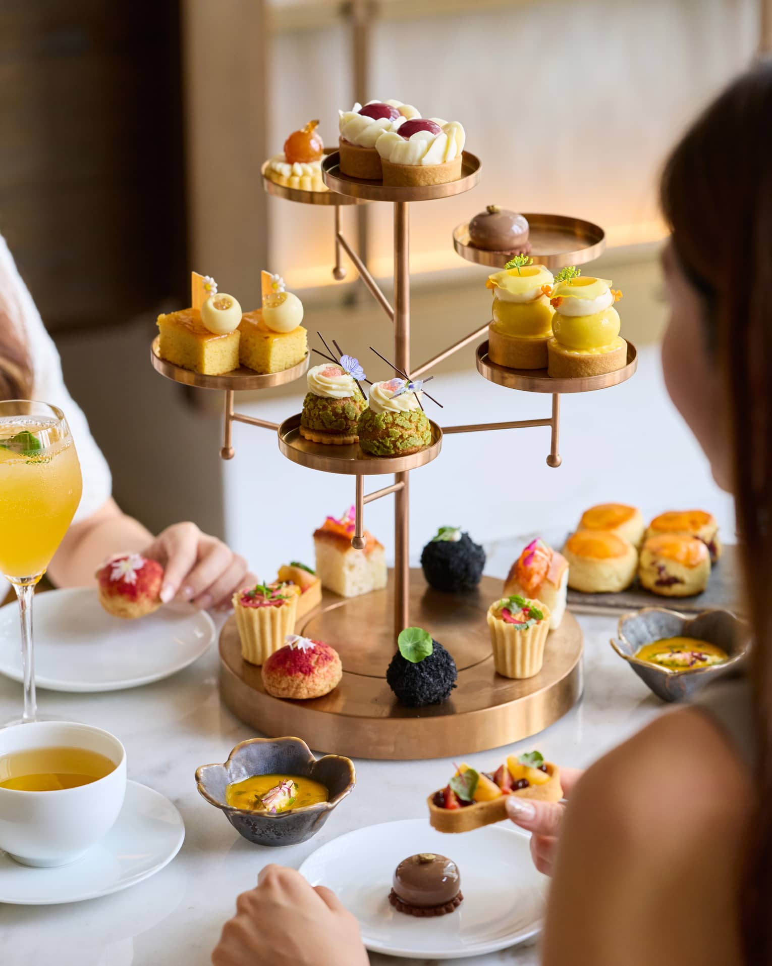 Tree-shapped serving tray filled with bite-sized pastries for afternoon tea