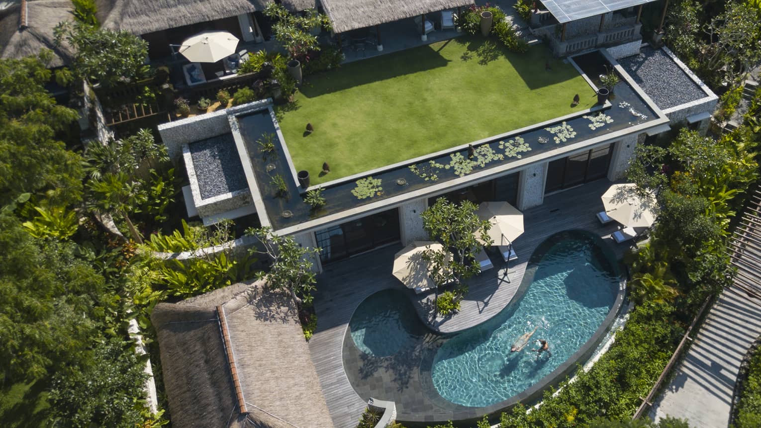 Aerial view of a large Balinese villa with private kidney-shaped pool