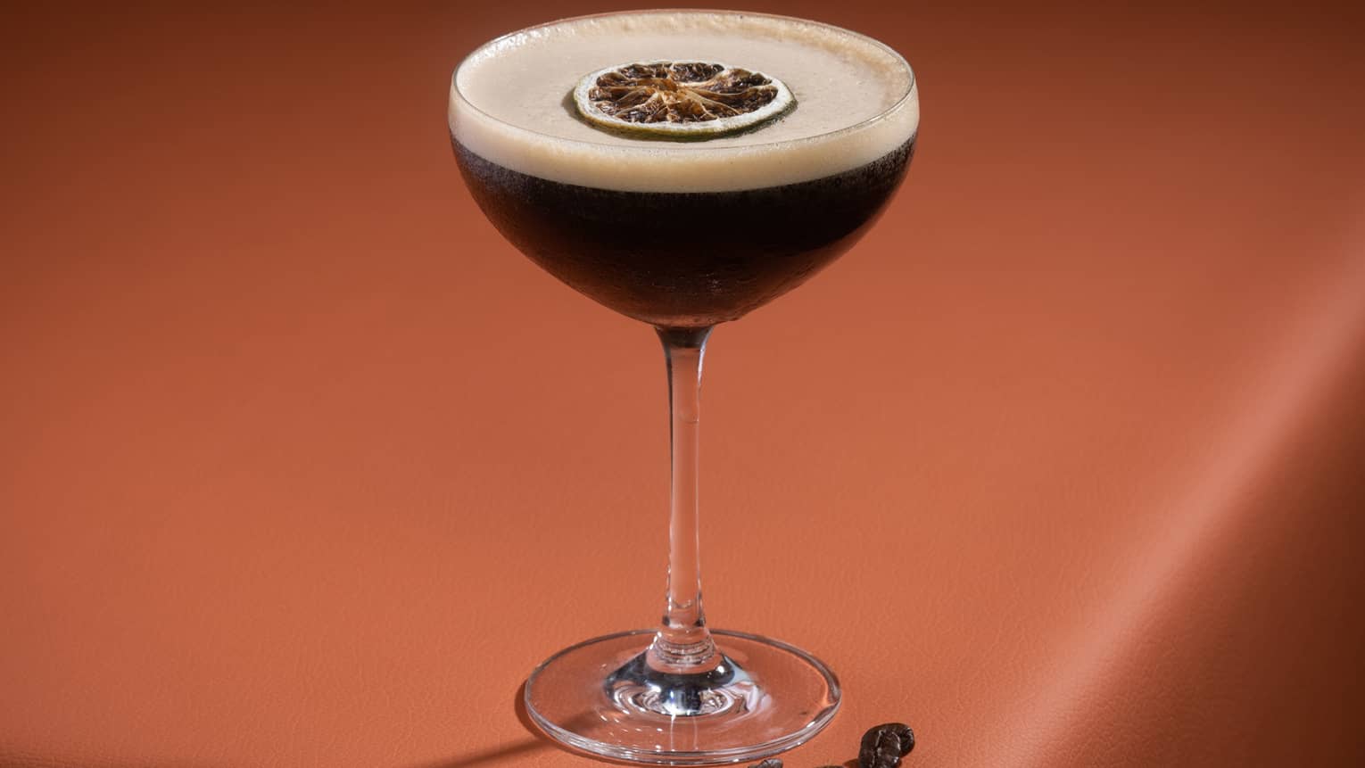 Kaldi Martini in a coupe glass and topped with a dried orange slice