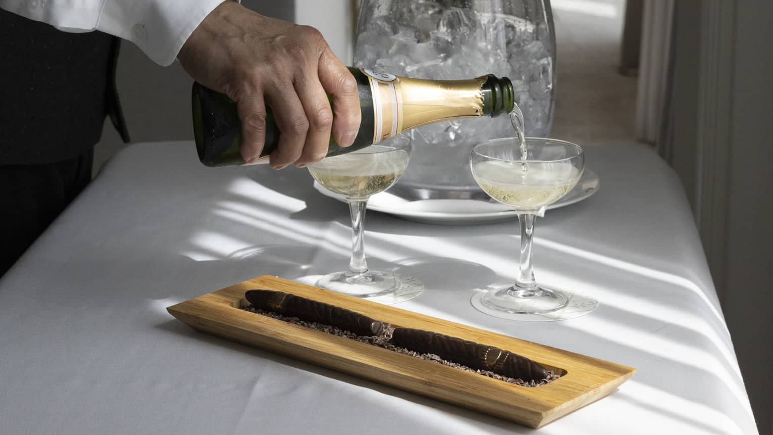 Wine being poured into two glasses.