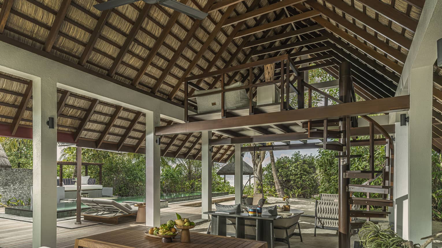 Open-air Beach Villa with Pool dining area with steepled roof and balcony