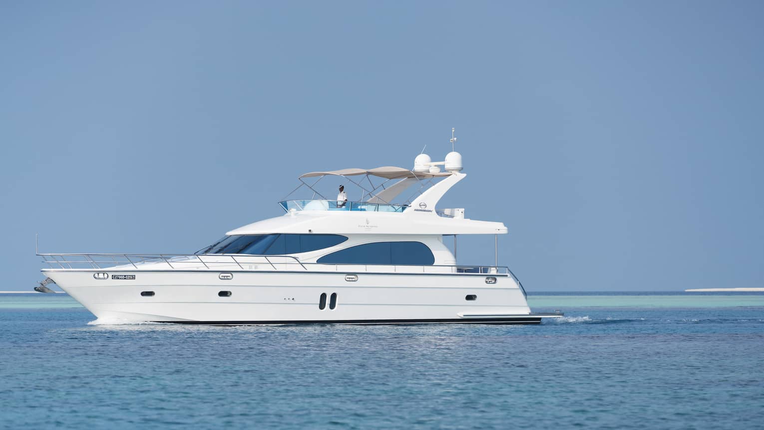 Small white private luxury yacht sailing on ocean