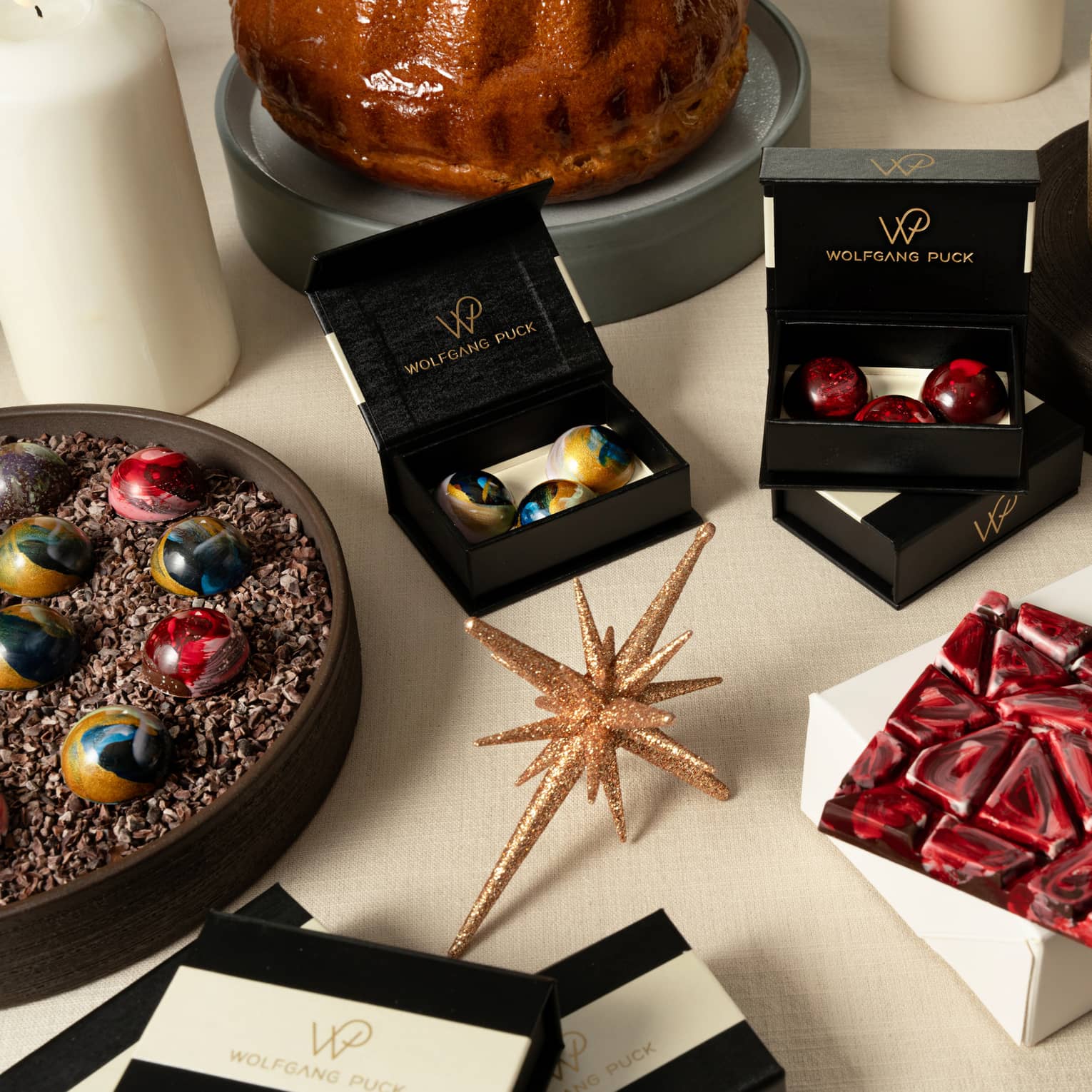 Artful holiday desserts and chocolates in various black and white gift boxes