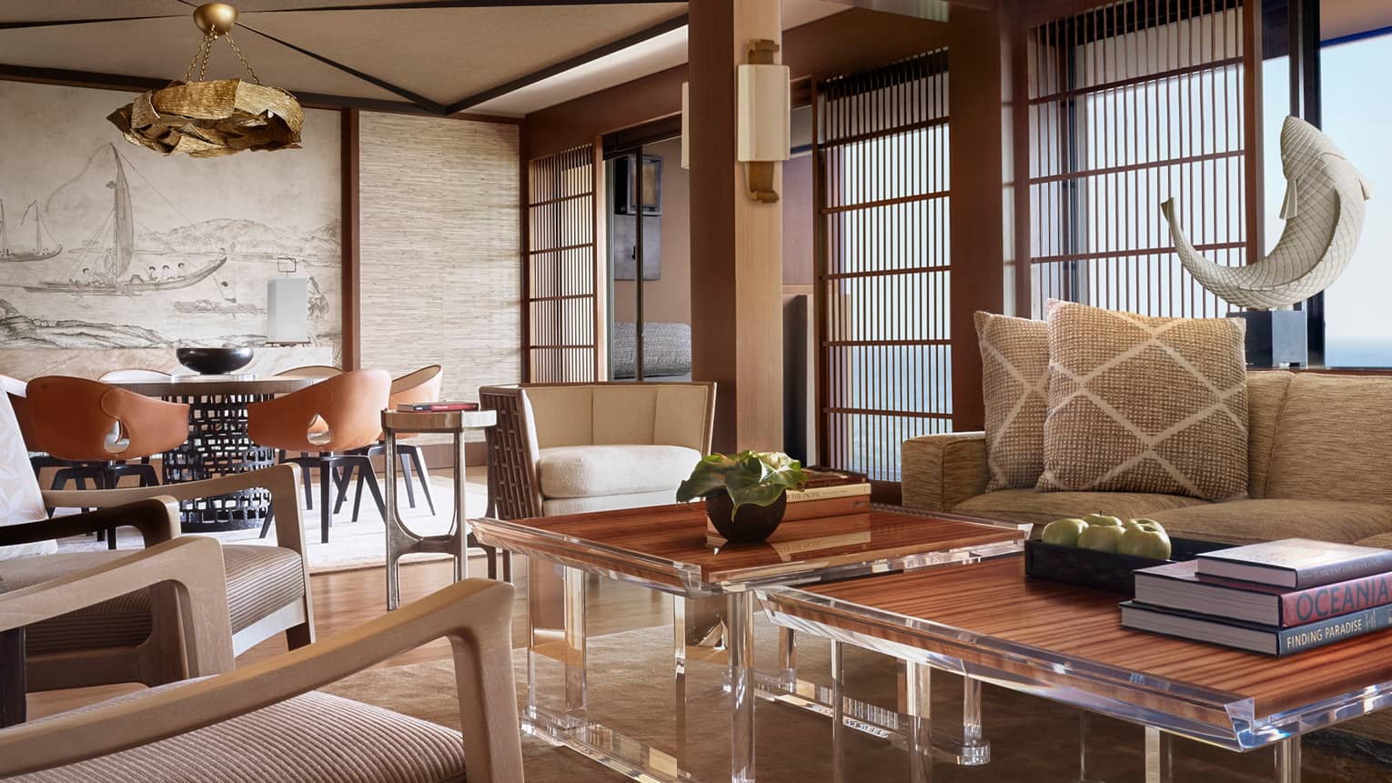 Manele Suite living room with modern furniture with wood accents, shutters, woven pillows