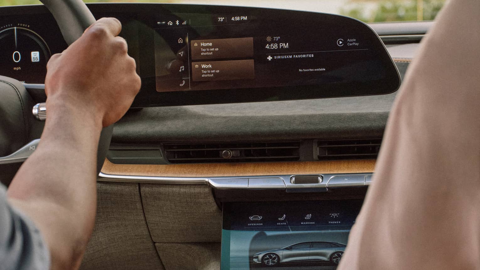 One guest driving a car while the other guest adjusts the controls