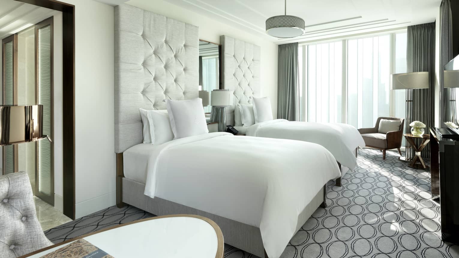 Premier Room double beds with white linens, headboards, grey patterned carpet