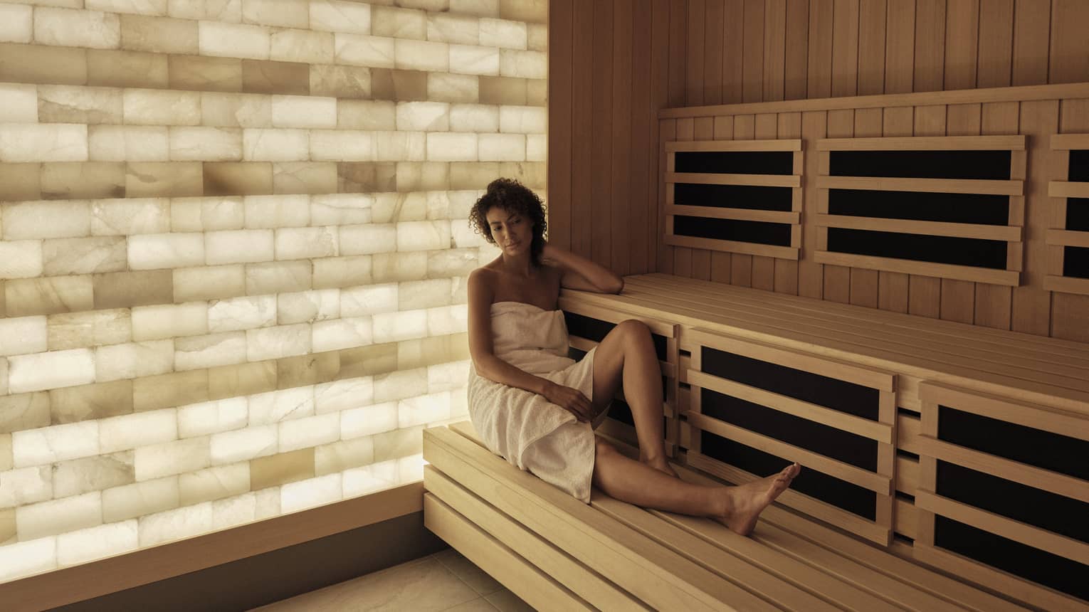 Woman relaxes in the salt-wall sauna