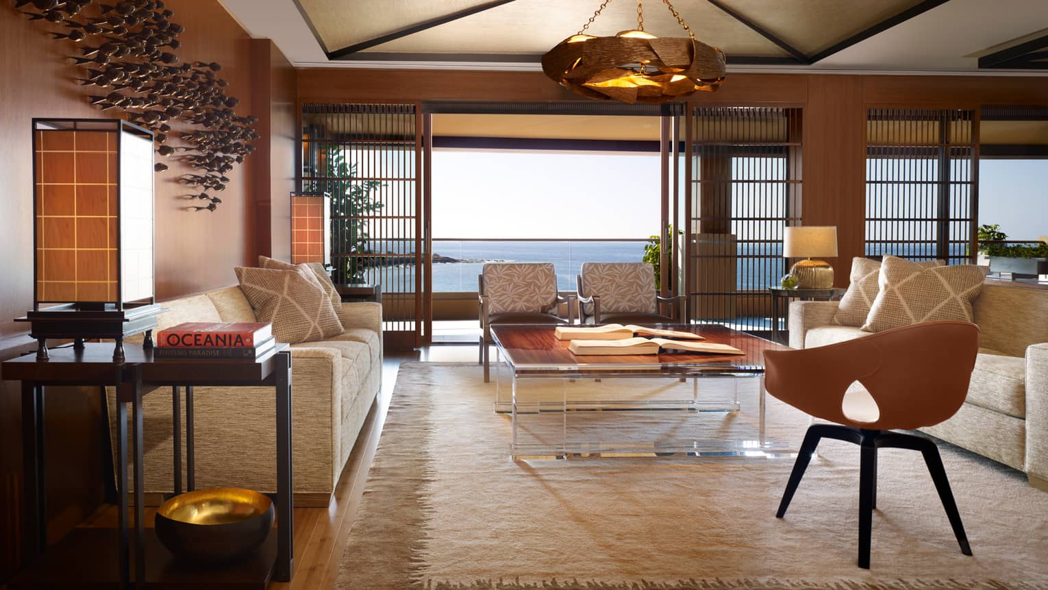 Alii Royal Suite spacious seating area with bespoke furnishings, mid-century style sofas, chairs, light
