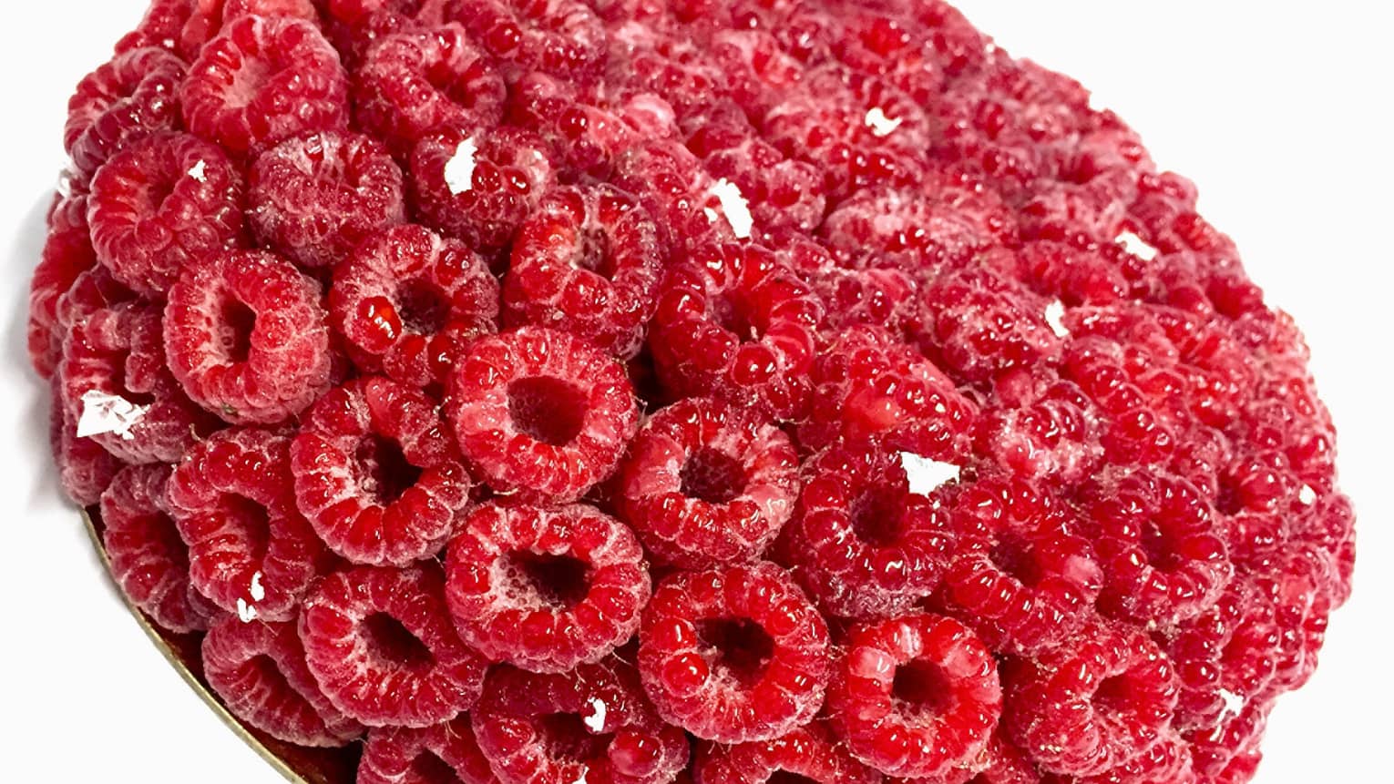 Raspberry anniversary cake, round and completely covered in fresh raspberries