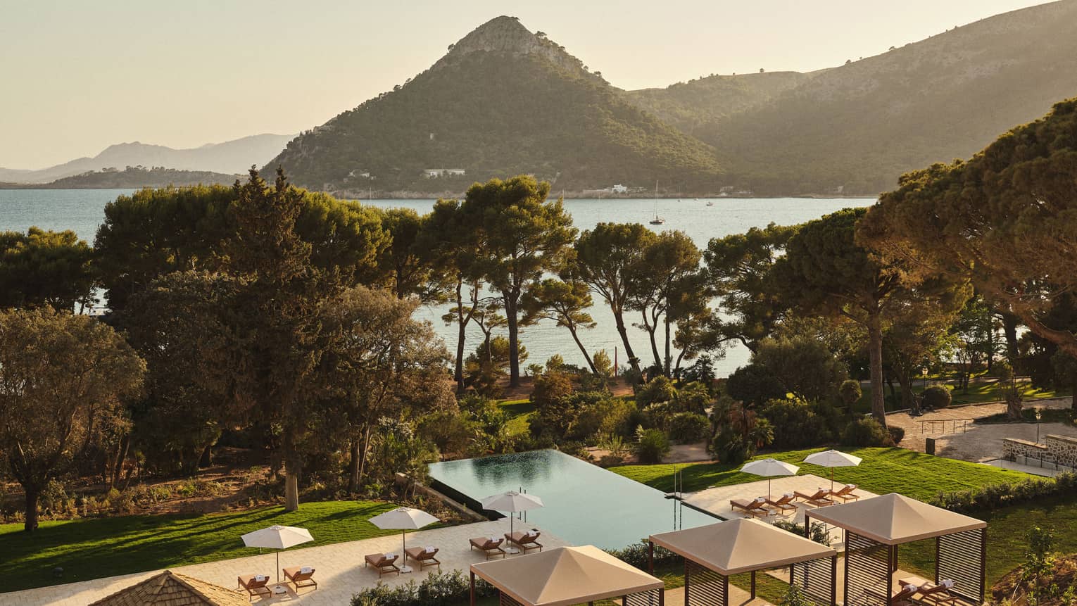 View of pool and ocean/mountain in background