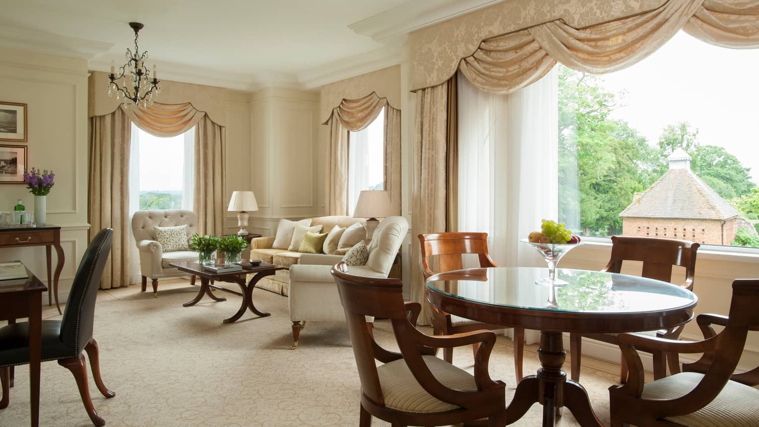 Park Suite tall sunny windows with silk curtains, seating area, dining table