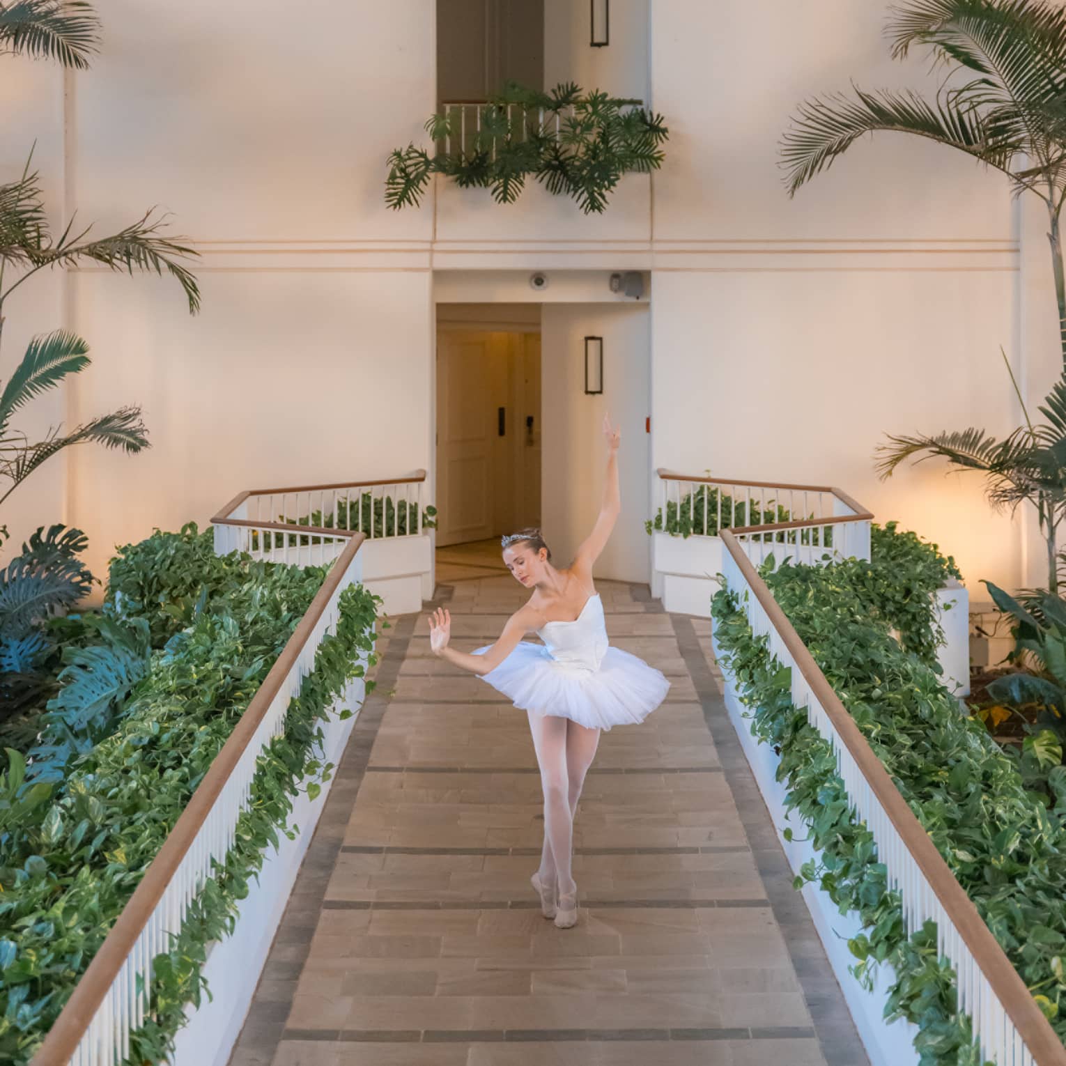 A ballet dancer performs on an outdoor walkway at resort