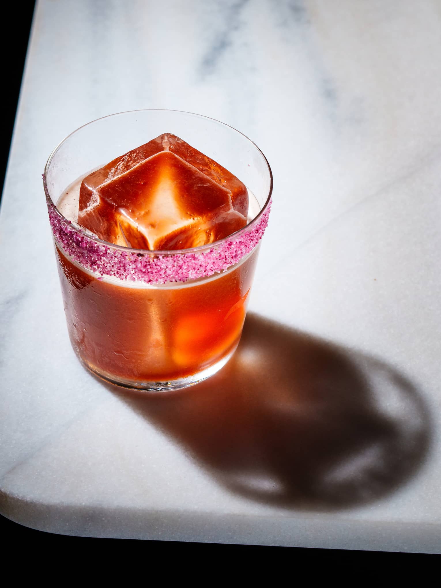 Red cocktail on a marble table