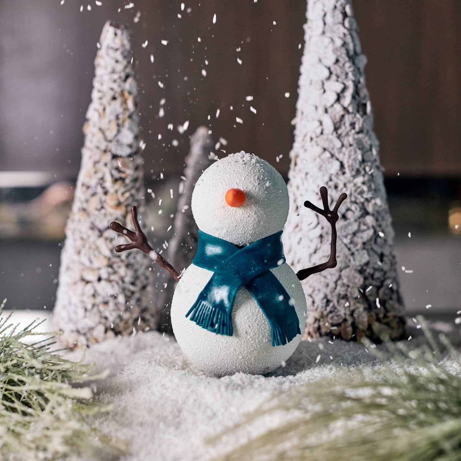 A small snowman and Christmas tree decoration