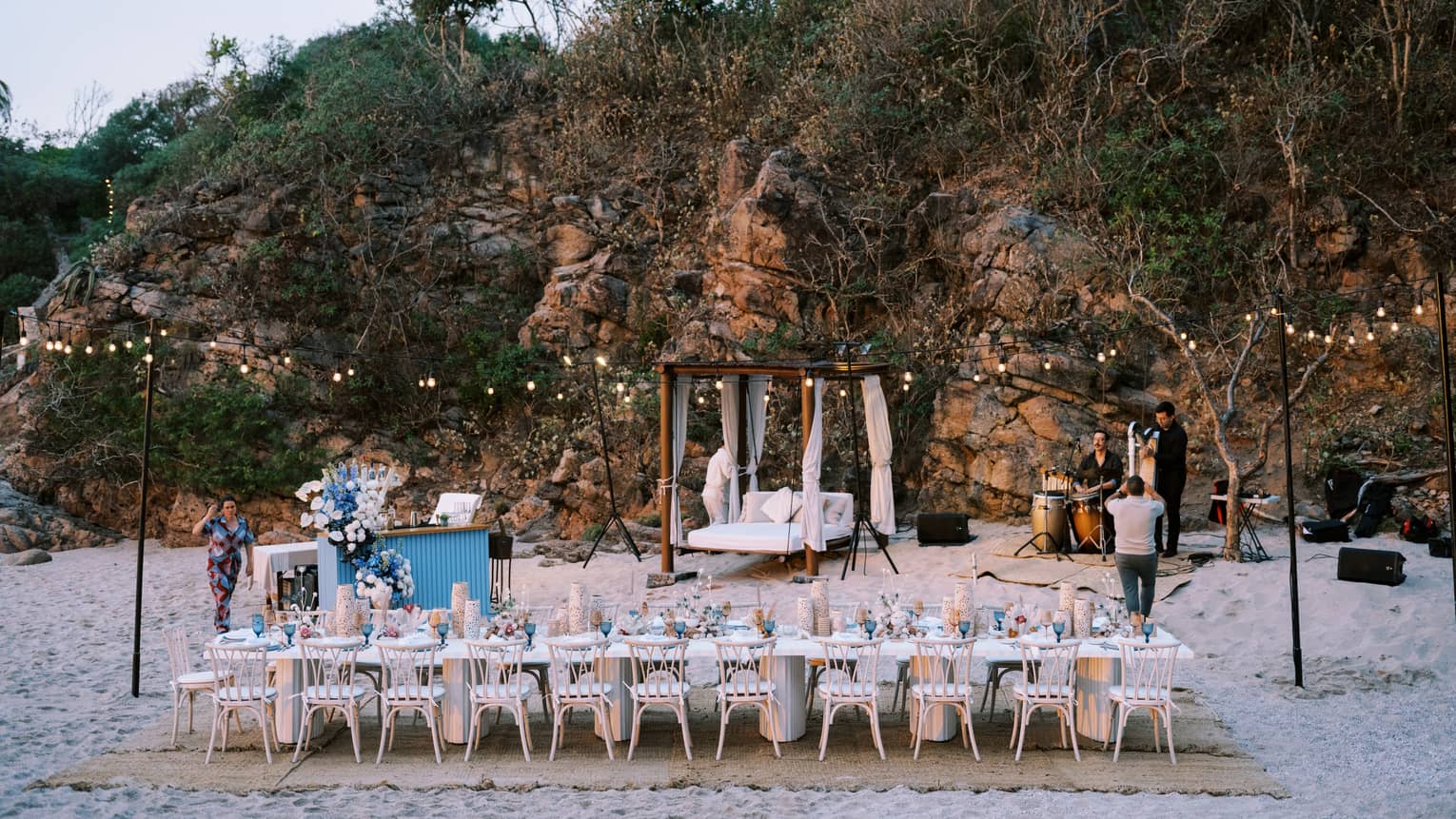 Group dining table setup on the beach