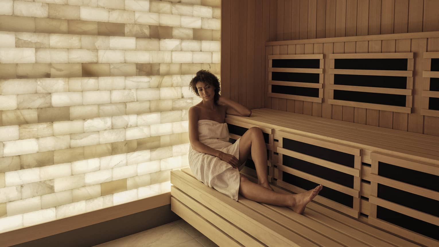 Woman relaxes in the salt-wall sauna