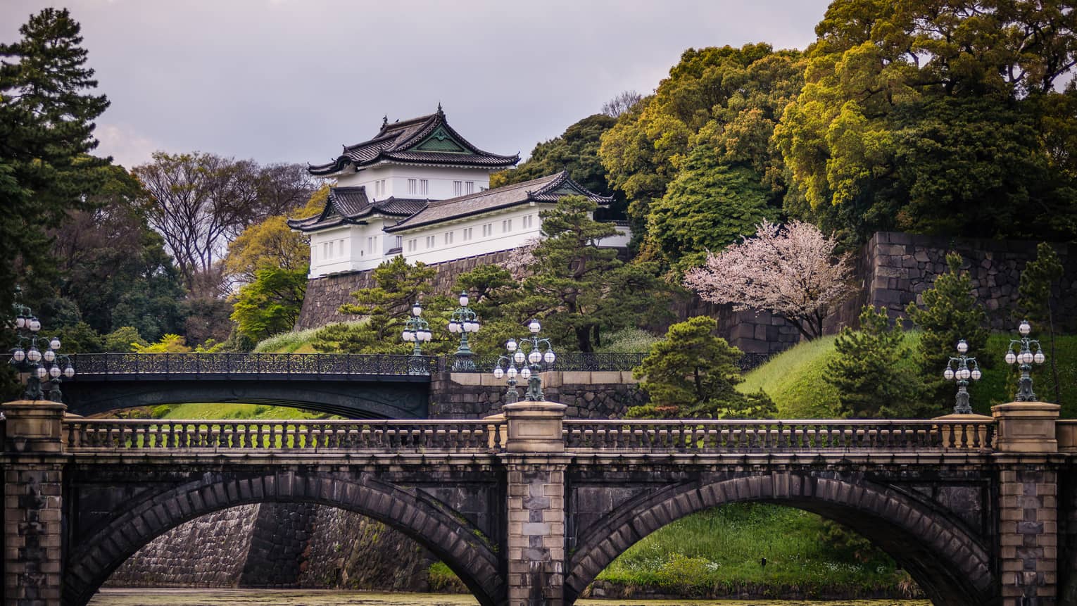 Historic brick bridge, Otemachi building tucked in hillside and trees