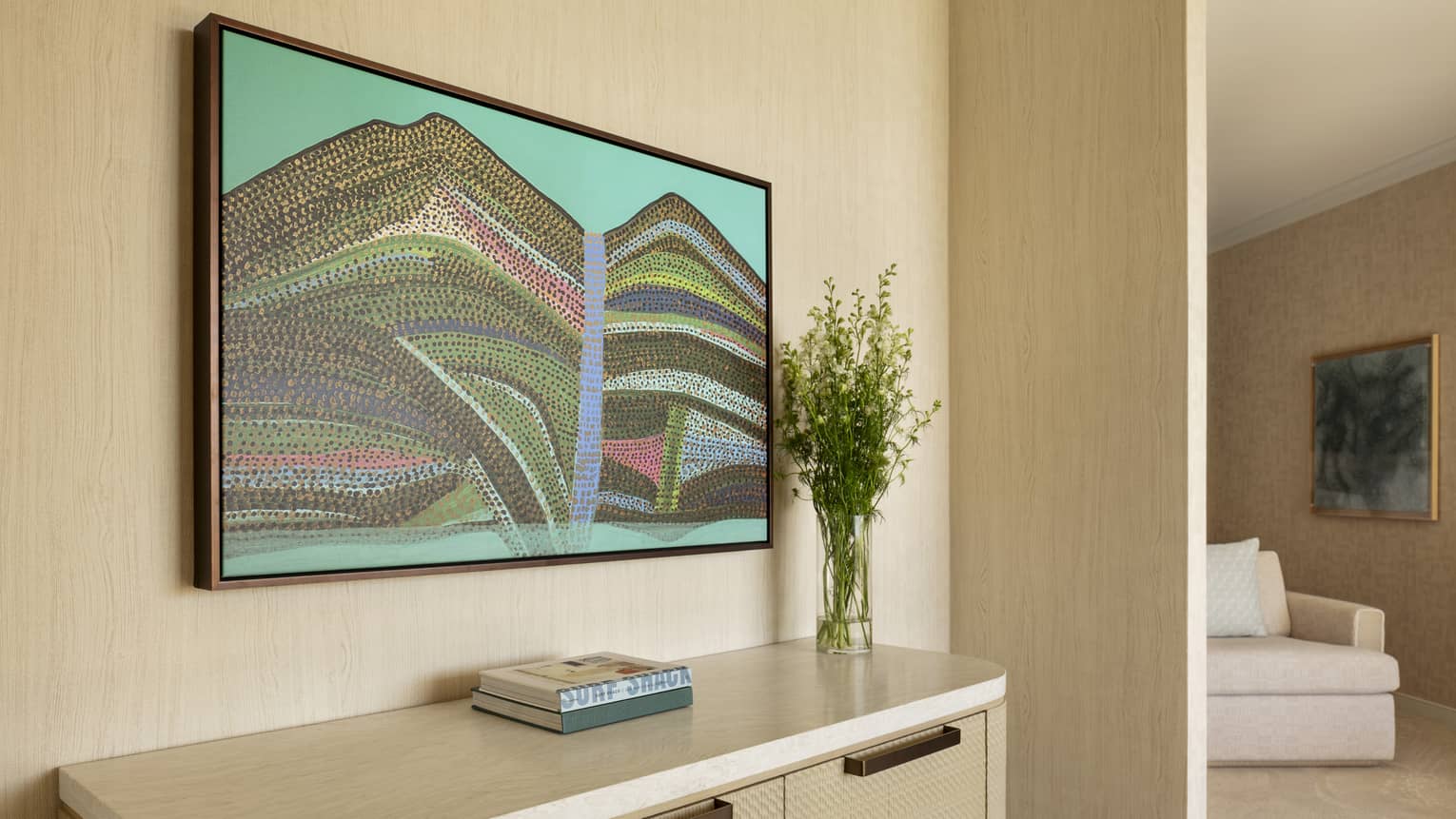 Contemporary resort suite hallway featuring an abstract Hawaiian painting above a dresser