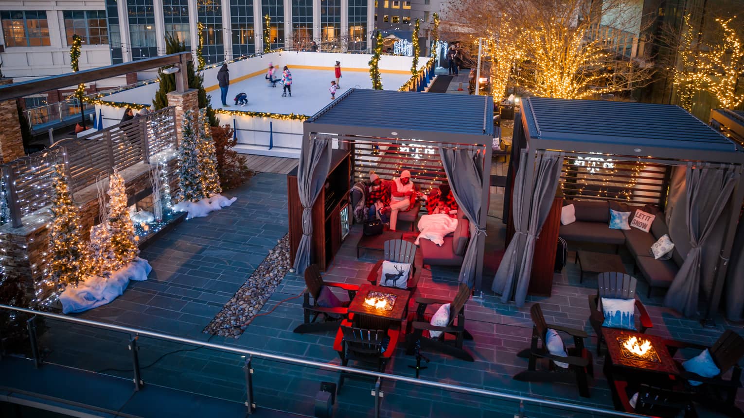 A rooftop with ice skating, and chalets.