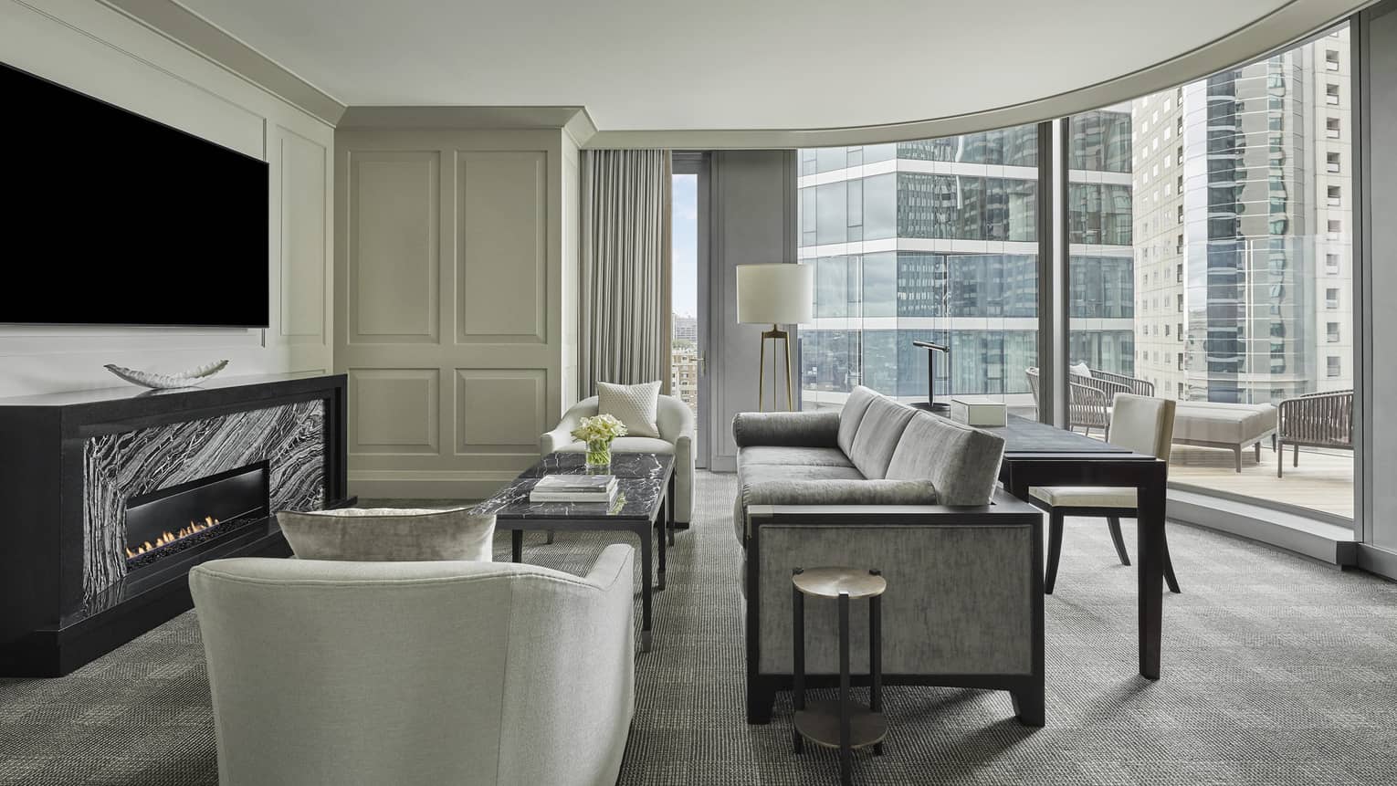 The guest sitting area in the charles suite opens to an outdoor terrace, overlooking downtown boston