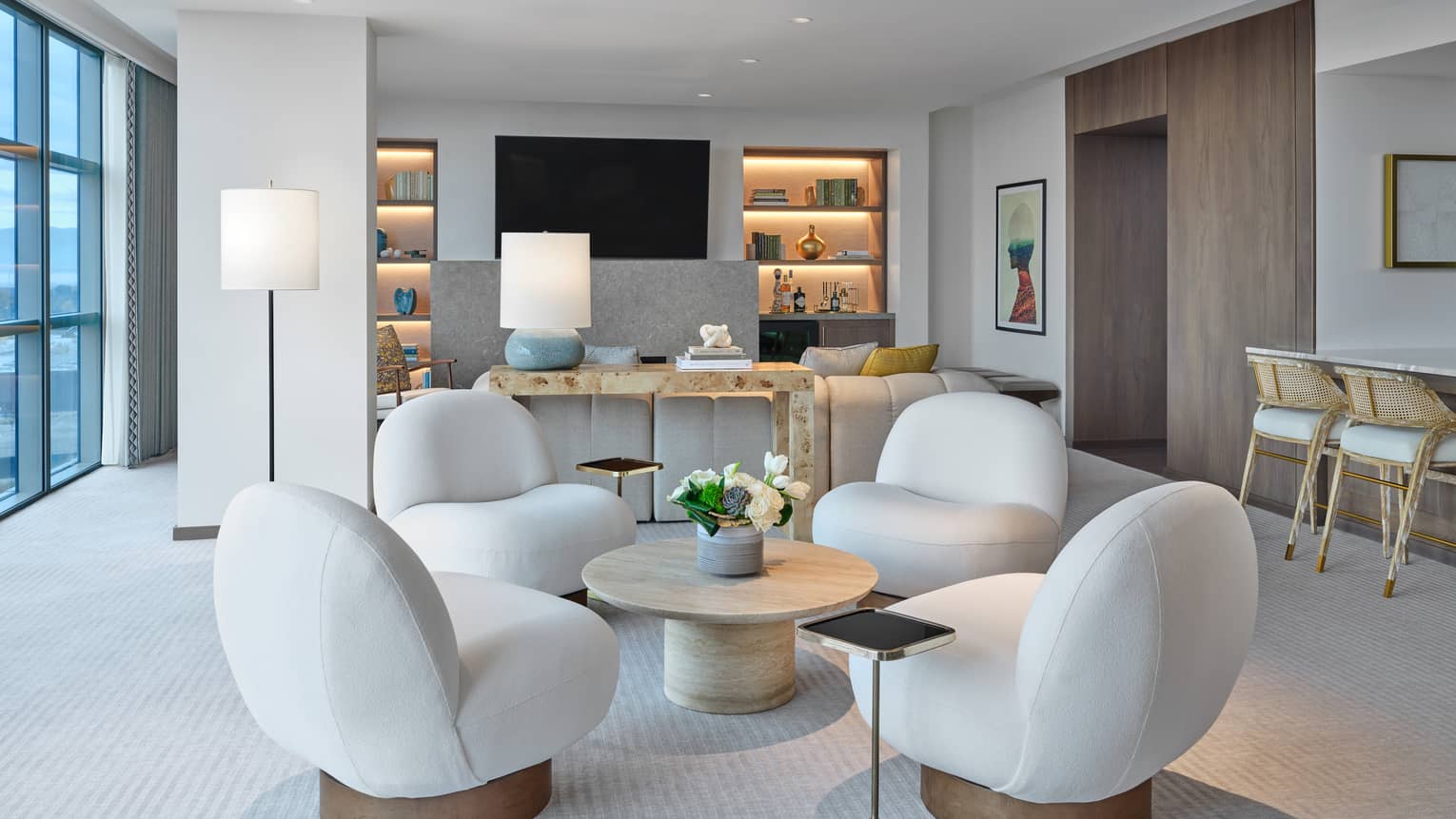 Living room with four modern chairs set around a round coffee table