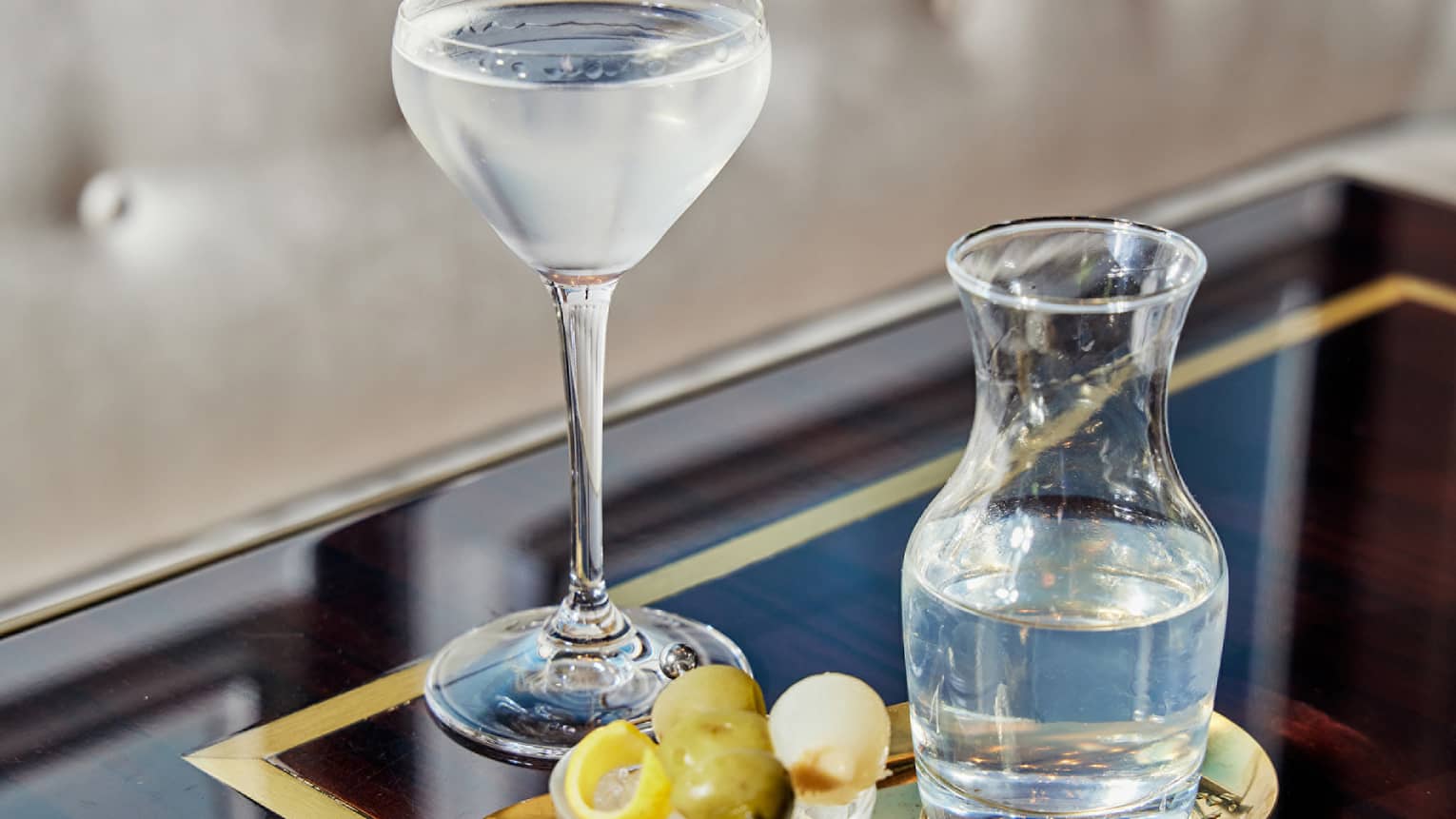 A pitcher of water and a glass.