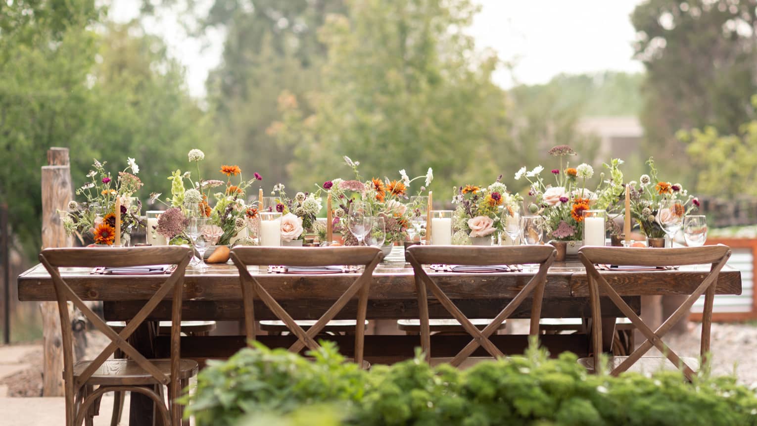 A table outside covered in flowers.