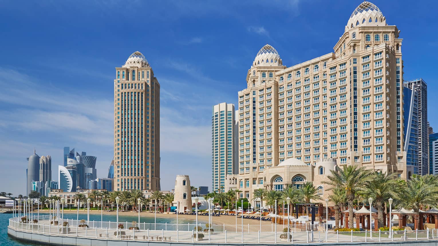 Four Seasons Doha hotel high rise building exterior, beach and palm trees