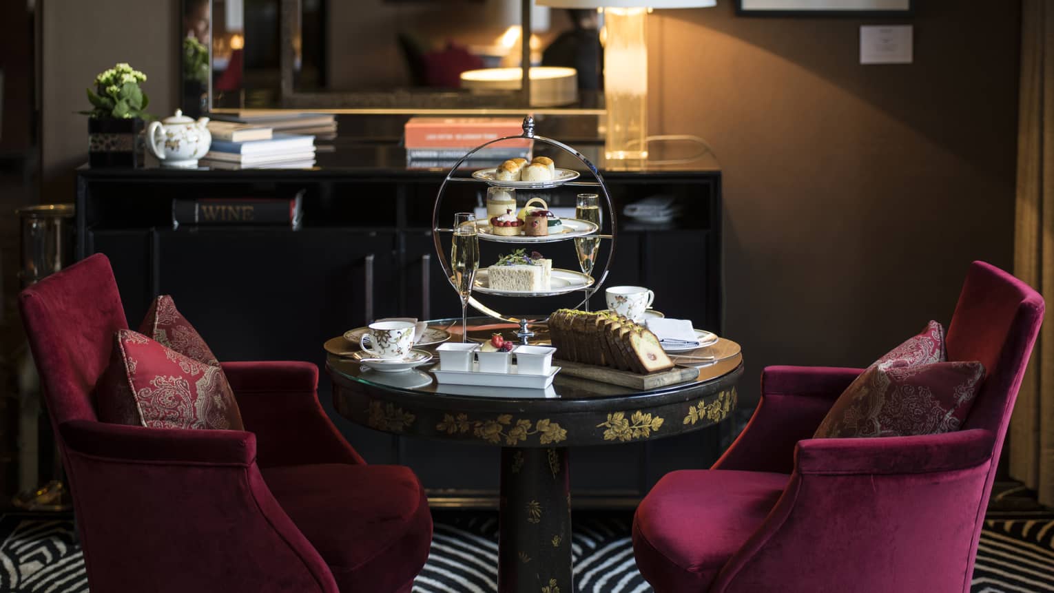 Tea, bread and assorted treats are ornately displayed in a cozy lounge