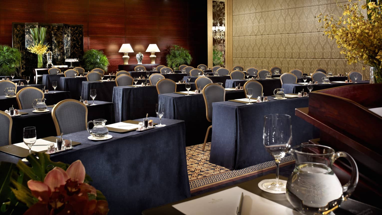 Empty conference room with blue chairs, tables with blue tablecloths