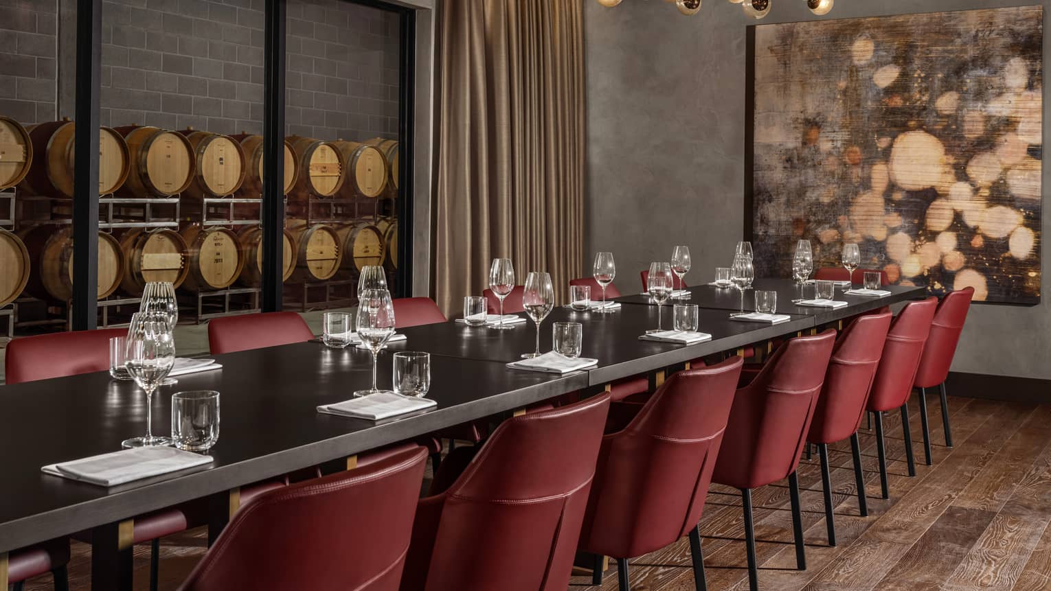 A long table with red chairs at a restaurant.