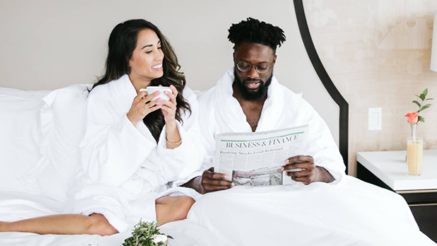 A couple enjoys breakfast in bed together