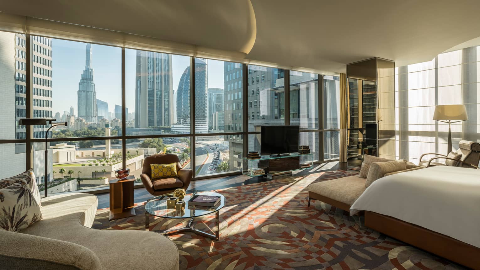 Bright Penthouse Suite with bed, sofa in front of wall of floor-to-ceiling windows with Dubai city views