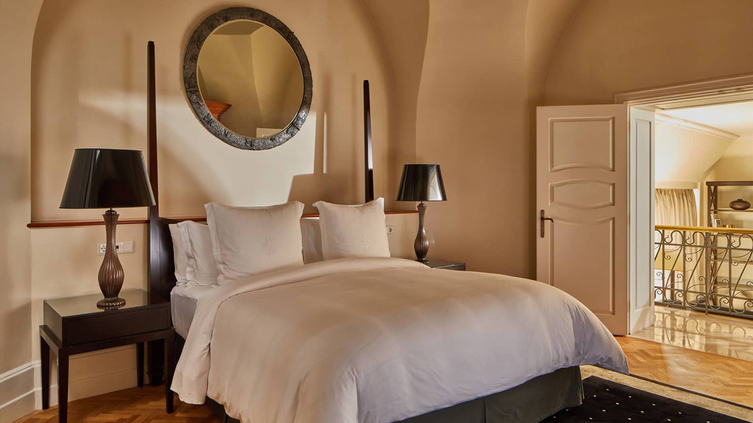 A bed with two side tables and lamps.