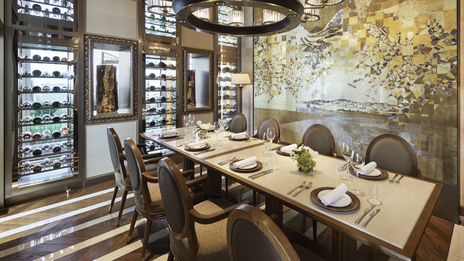 Est dining room with table set for eight, muted cream decor, circular chandelier, hardwood floors