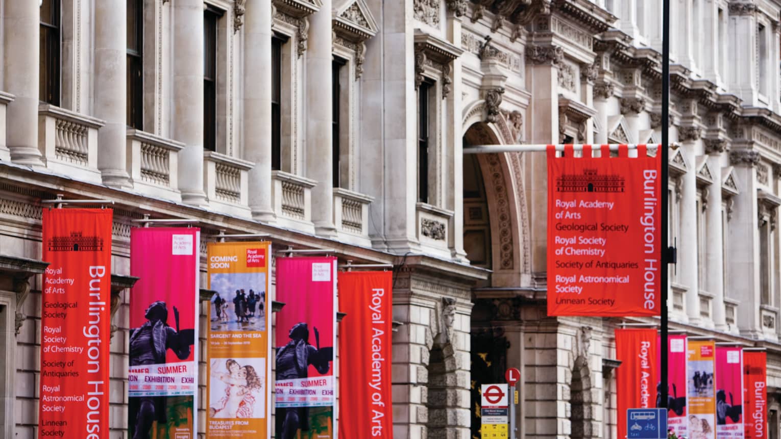 London museum gallery exterior with red flags