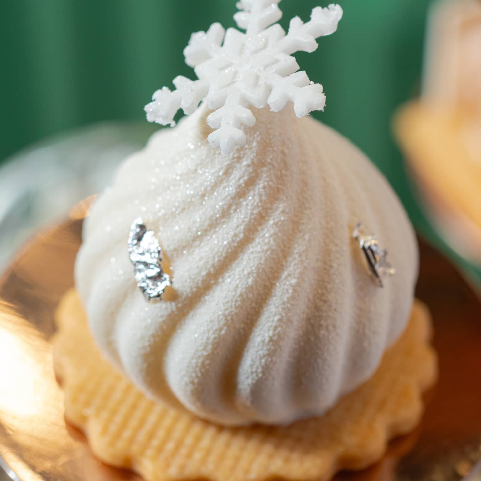 Festive afternoon tea pastry topped with a snowflake