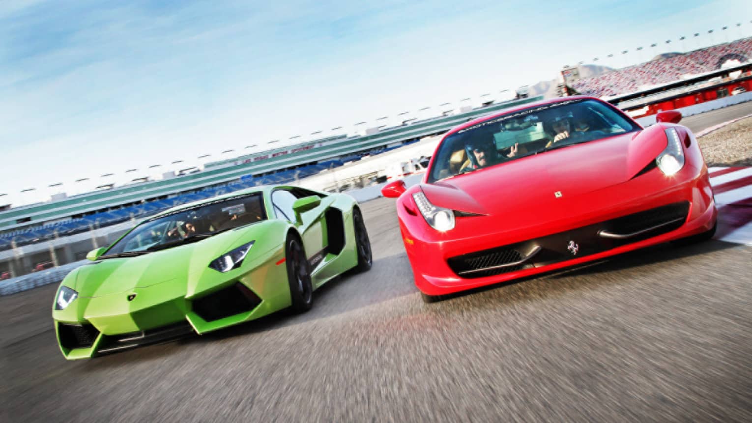 Red and green sports cars on race track