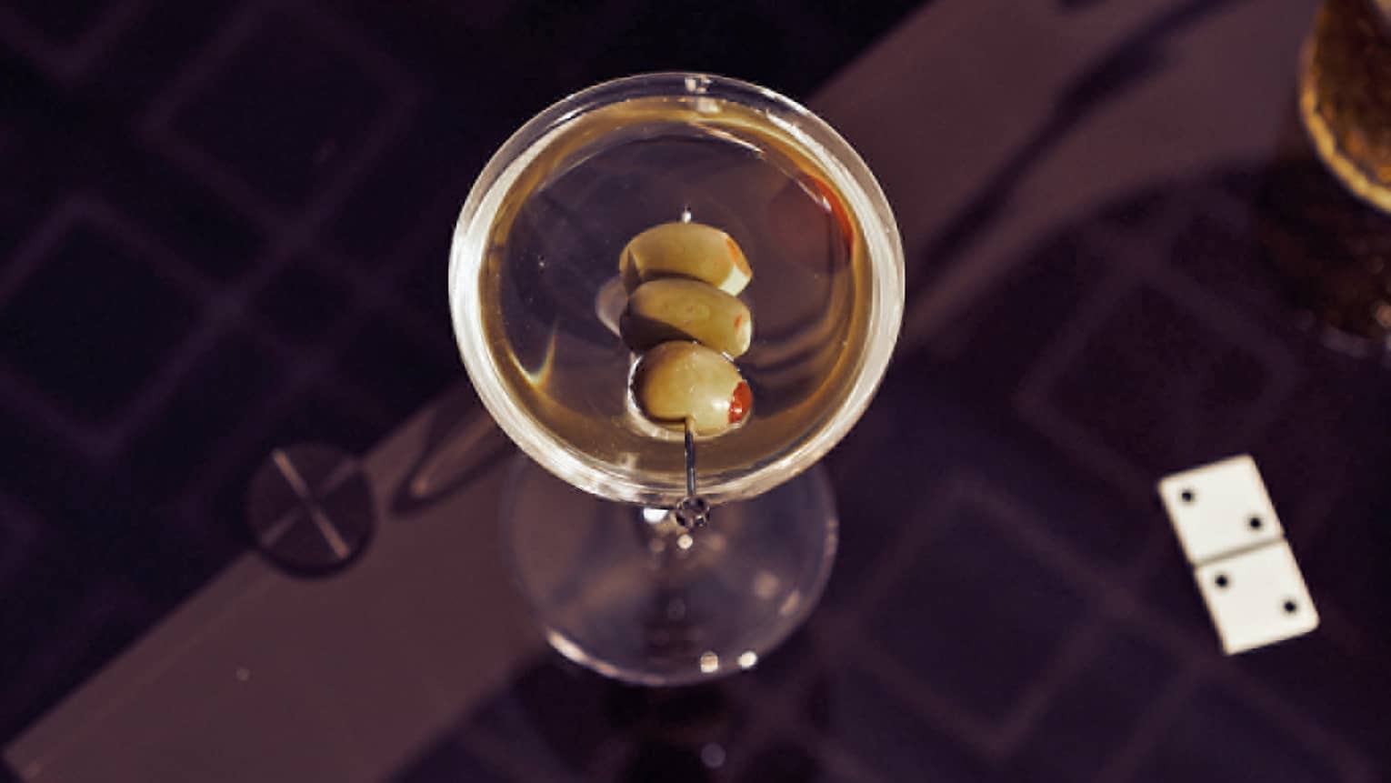 A martini on a black table.