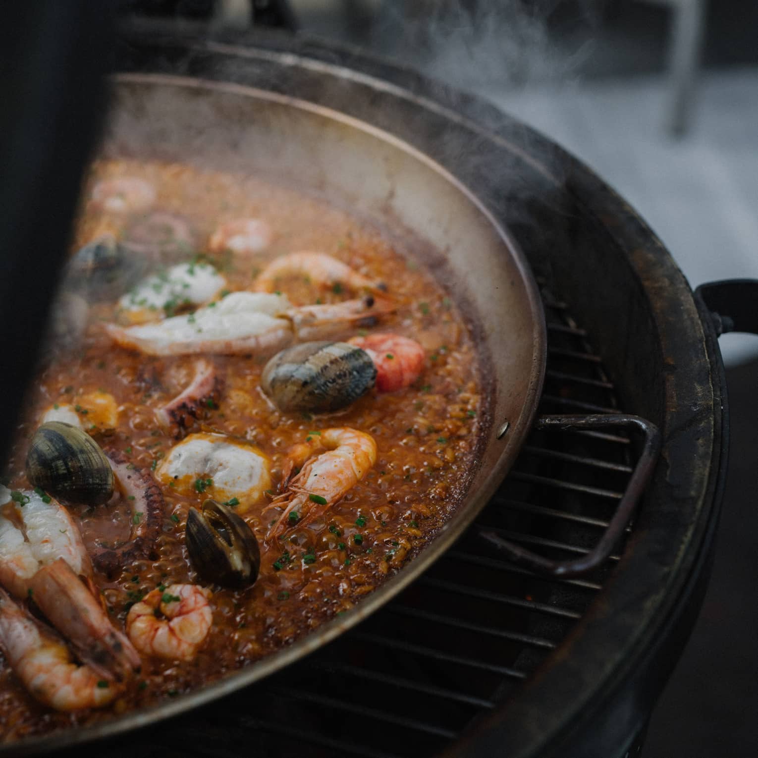 Paella cooking on grill