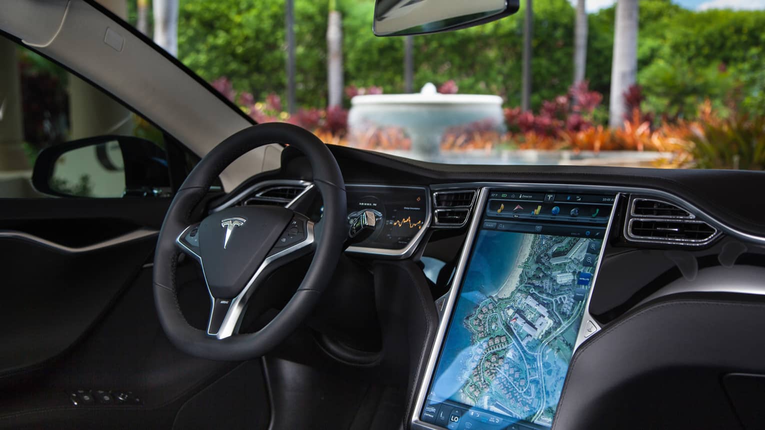 Close-up of Tesla car wheel, dashboard with touchscreen