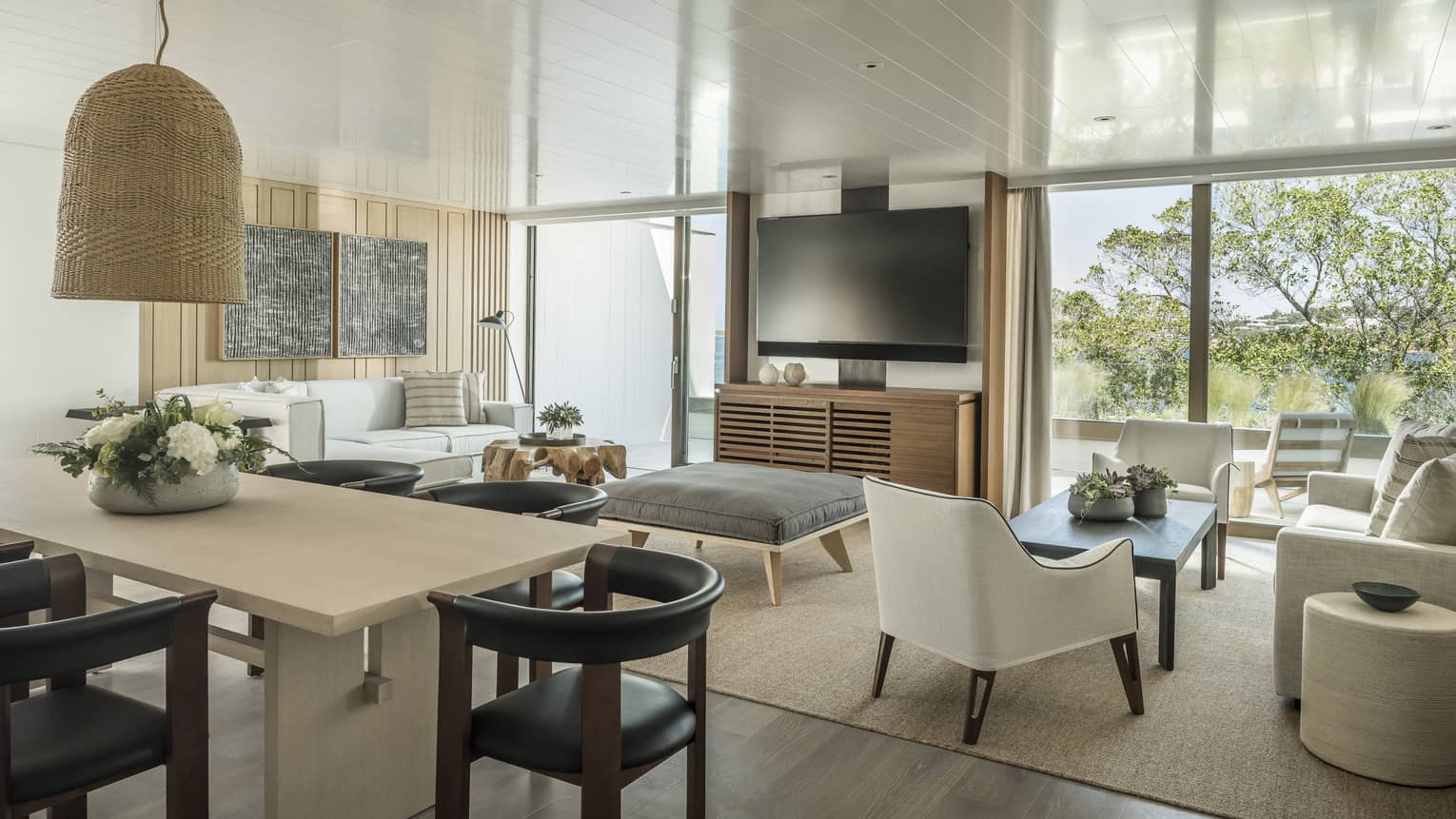 Nafsika One Bedroom Terrace Suite with Pool living room with white sofa, arm chair, ottoman, high table with leather stools, flat screen TV