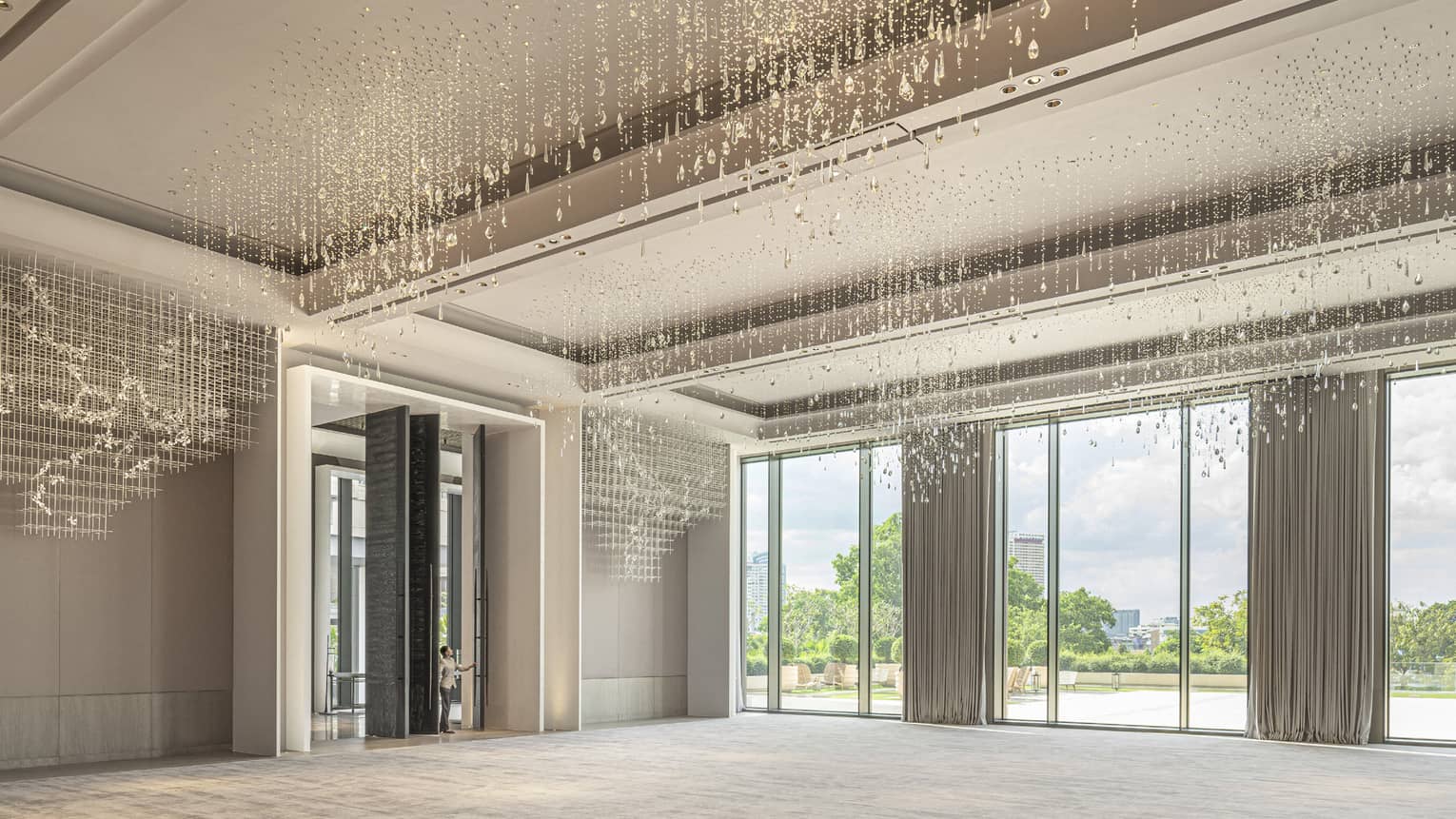Grand Ballroom with cream-coloured carpeting and drapes, floor-to-ceiling windows and hanging crystal beads 