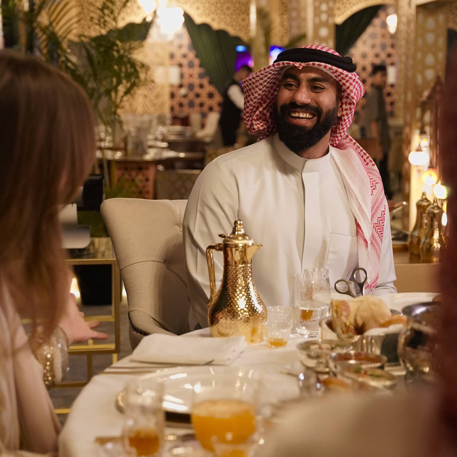 Two people sit a table for a Ramadan meal