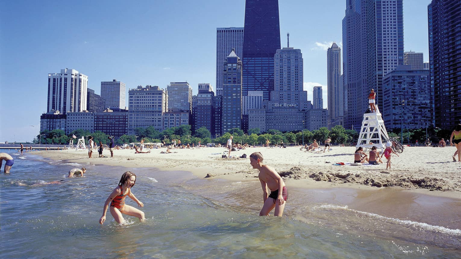 Young children playing on a beach.